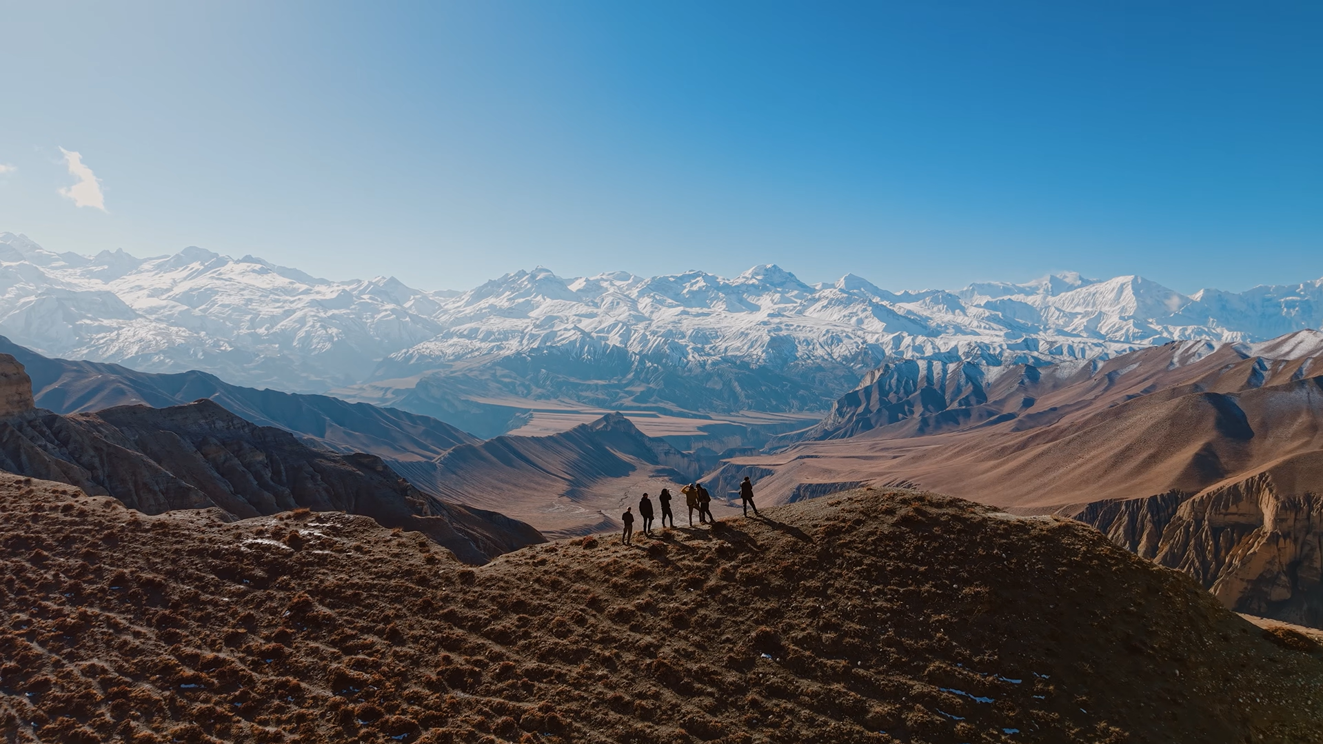 Trekkers overlooking Nepal's snow-capped Himalayan range