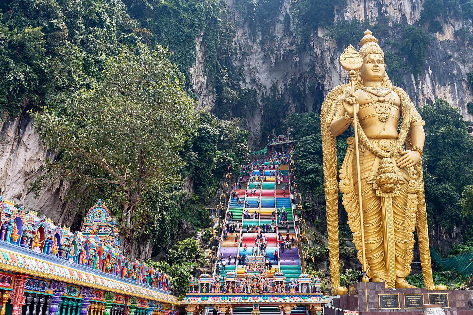 The golden Murugan statue beside the coloured steps up to Batu Caves