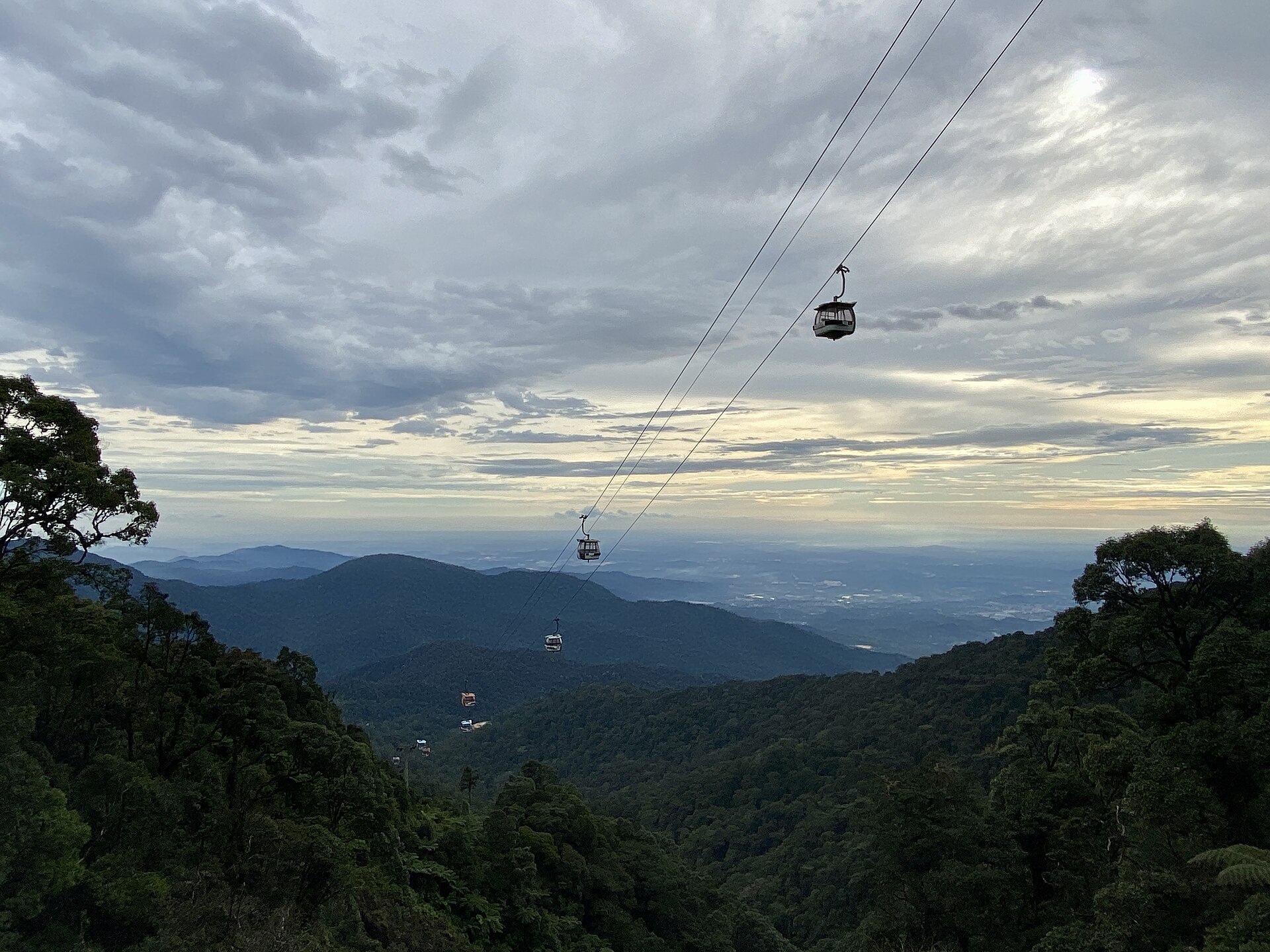 Cable car gondolas above the forested hills on the way up to Genting Highlands