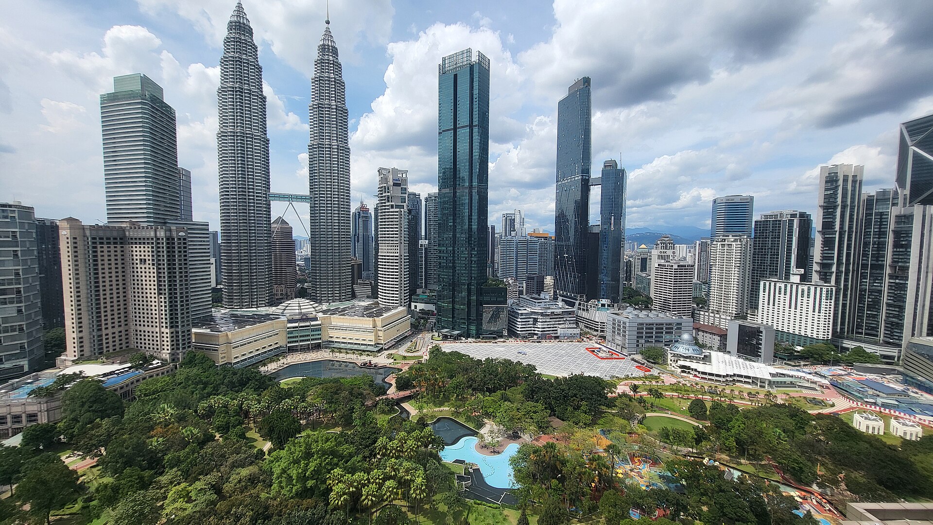 The Petronas Twin Towers and the city skyline above the trees and pool of KLCC Park, Kuala Lumpur